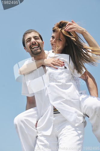 Image of happy young couple have fun on beach