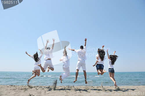 Image of happy people group have fun and running on beach