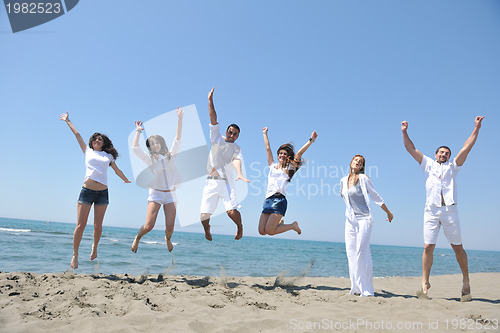 Image of happy people group have fun and running on beach