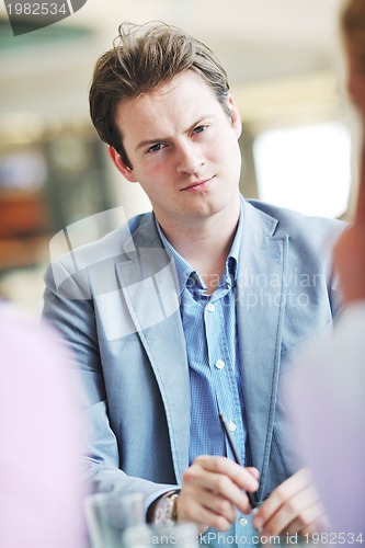 Image of young business man alone in conference room
