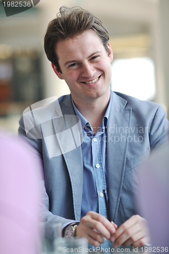 Image of young business man alone in conference room