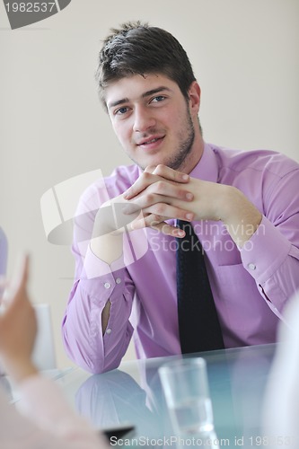 Image of young business man alone in conference room
