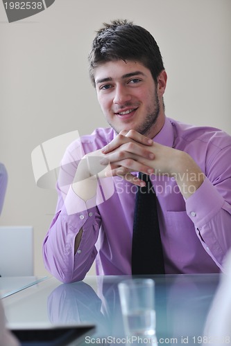 Image of young business man alone in conference room