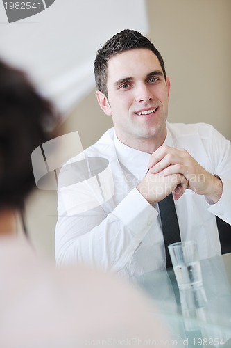 Image of young business man alone in conference room