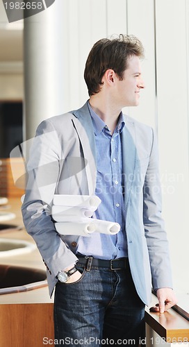 Image of young business man alone in conference room
