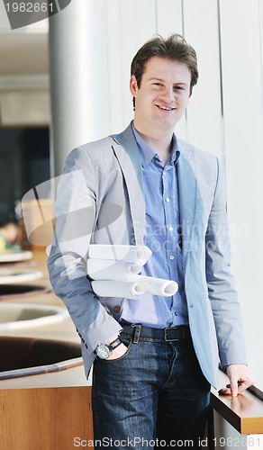 Image of young business man alone in conference room