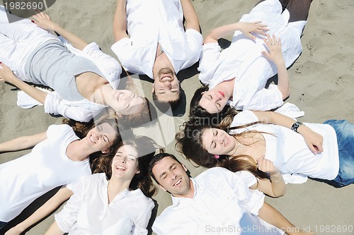 Image of Group of happy young people in have fun at beach