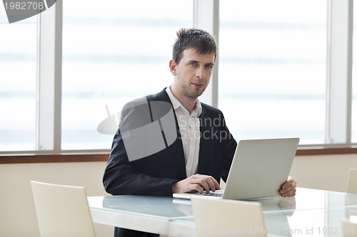 Image of young business man alone in conference room