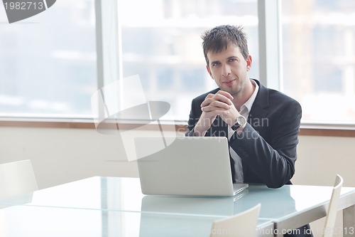 Image of young business man alone in conference room