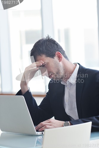 Image of young business man alone in conference room