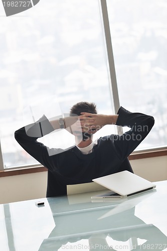 Image of young business man alone in conference room