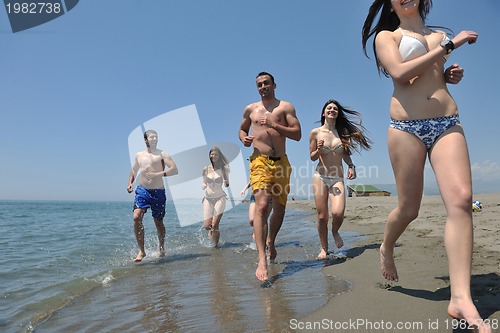 Image of happy people group have fun and running on beach