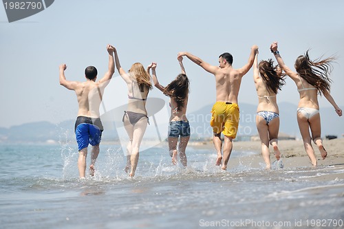 Image of happy young  people group have fun on beach