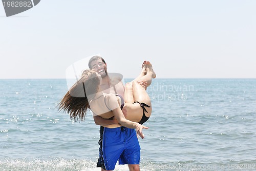 Image of happy young couple have fun on beach