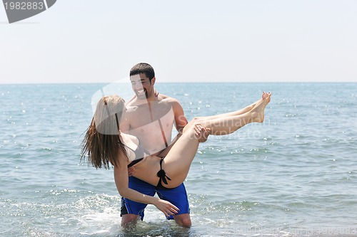 Image of happy young couple have fun on beach