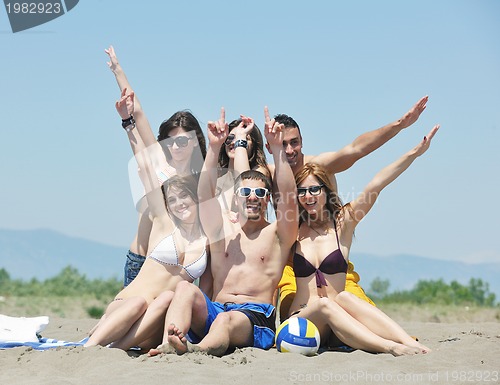 Image of Group of happy young people in have fun at beach