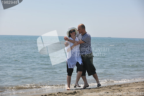 Image of happy young couple have fun on beach