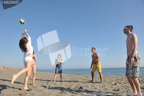 Image of young people group have fun and play beach volleyball