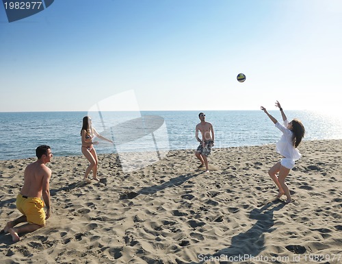 Image of young people group have fun and play beach volleyball