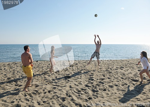 Image of young people group have fun and play beach volleyball