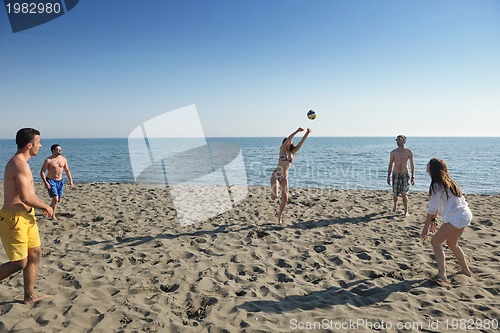 Image of young people group have fun and play beach volleyball