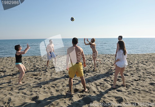 Image of young people group have fun and play beach volleyball