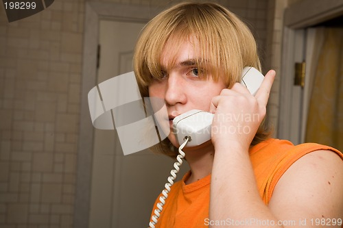 Image of Young man speaking by phone.