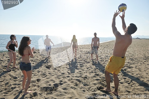 Image of young people group have fun and play beach volleyball