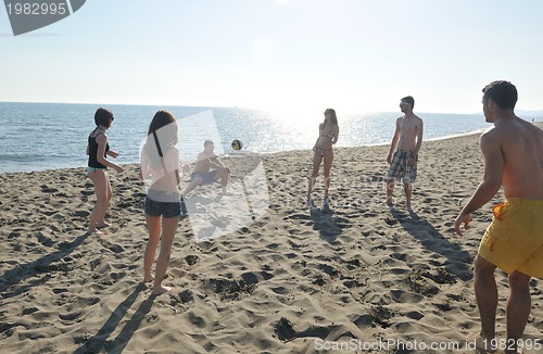 Image of young people group have fun and play beach volleyball