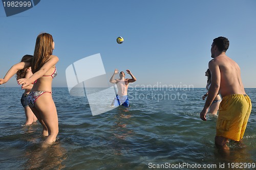 Image of young people group have fun and play beach volleyball