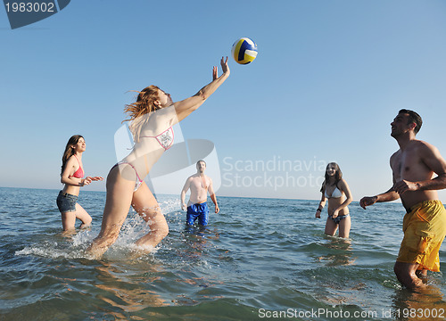 Image of young people group have fun and play beach volleyball