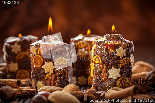 Image of Rustic Christmas candles with spices and  nuts