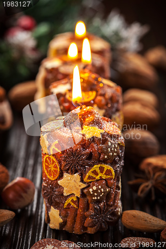 Image of Rustic Christmas candles with spices and  nuts