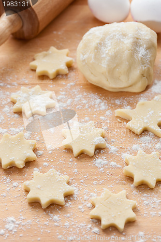 Image of Kitchen utensil with raw Christmas cookies