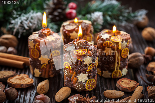 Image of Rustic Christmas candles with spices and  nuts