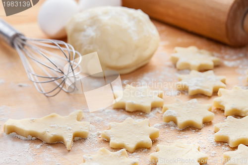 Image of Kitchen utensil with raw Christmas cookies