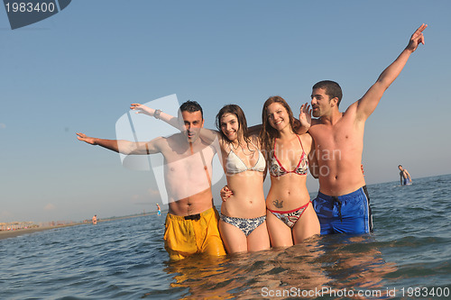 Image of happy people group have fun and running on beach