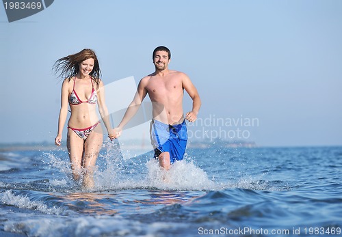 Image of happy young couple have romantic time on beach