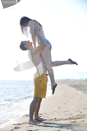 Image of happy young couple have romantic time on beach
