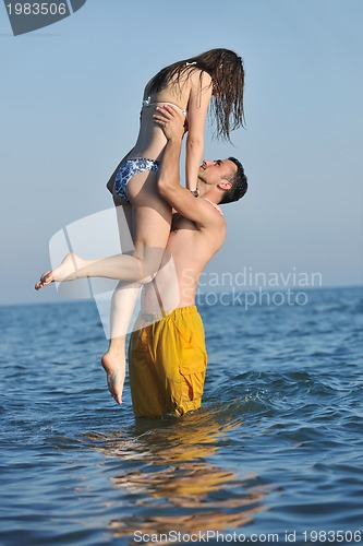 Image of happy young couple have romantic time on beach