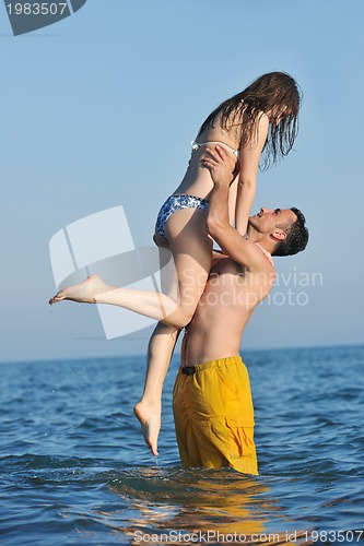 Image of happy young couple have romantic time on beach