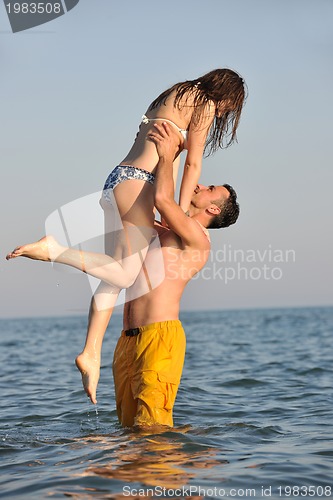 Image of happy young couple have fun on beach
