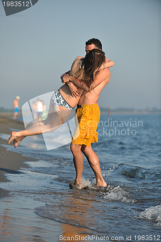 Image of happy young couple have fun on beach