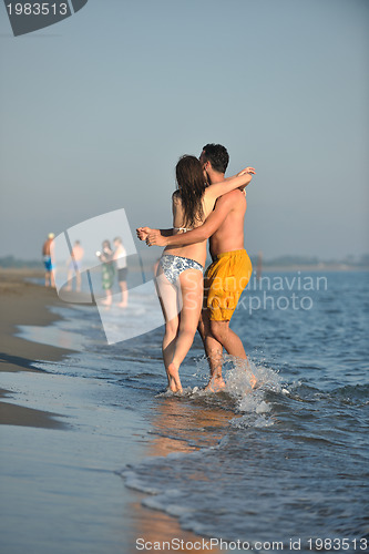 Image of happy young couple have fun on beach