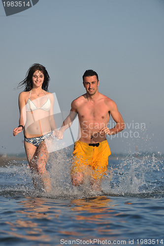 Image of happy young couple have fun on beach