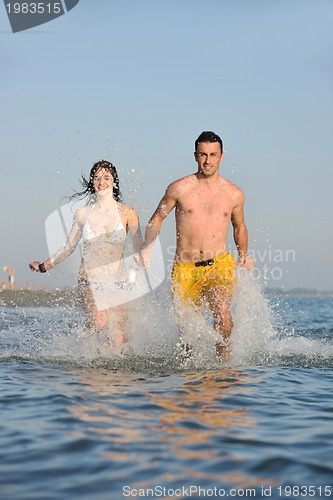 Image of happy young couple have fun on beach