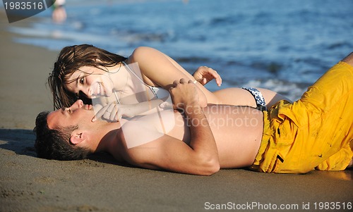 Image of happy young couple have romantic time on beach