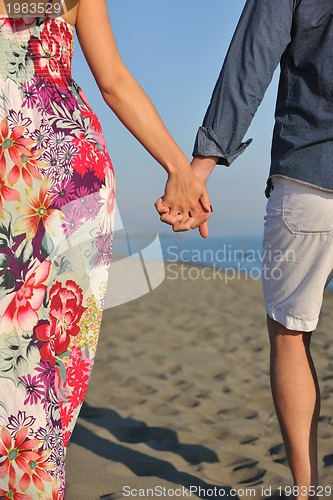 Image of couple on beach with travel bag