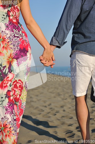 Image of couple on beach with travel bag