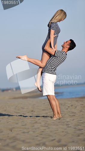 Image of happy young couple have fun on beach